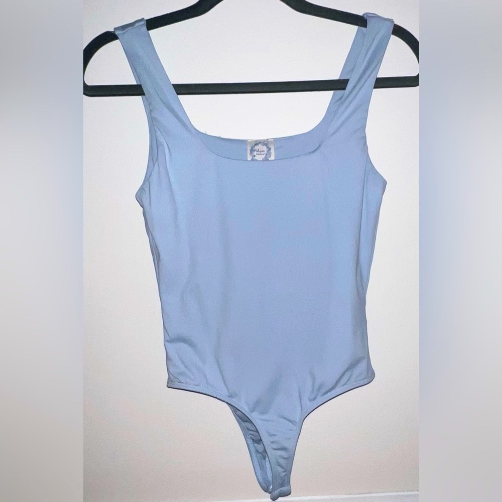 Light blue body suit.